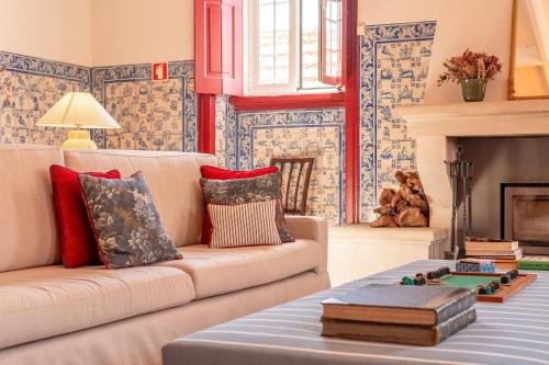 a living room with a couch and a fireplace at Pergola Boutique Hotel in Cascais