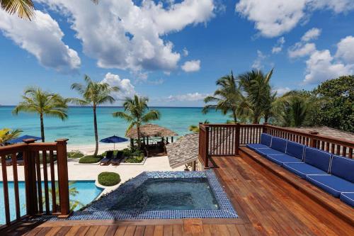 a view of the ocean from the deck of a resort at Newly Renovated Notos Cove Villa Property in Love