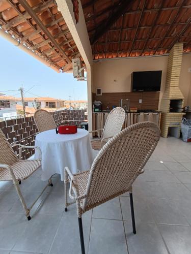 a white table with chairs and a red plate on it at Apartamento downtown in Beberibe