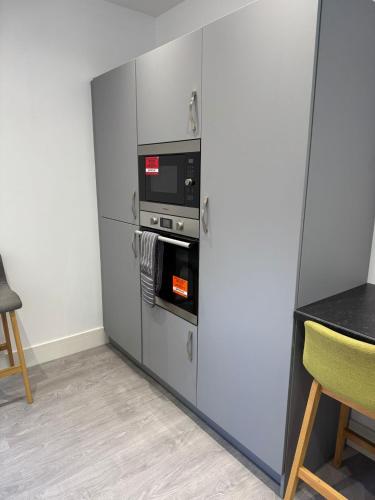 a kitchen with a refrigerator with a microwave at Nest in Northumberland in Blythe