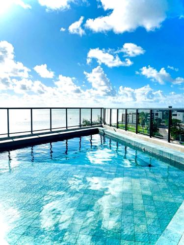 a swimming pool on top of a building at Flat de luxo em frente ao mar in João Pessoa
