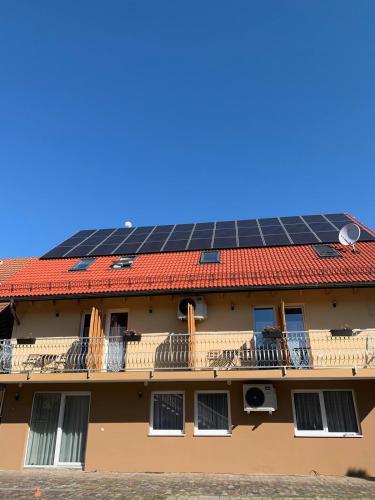 a building with a roof with solar panels on it at Molnár Apartman Zamárdi in Zamárdi