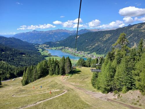 a gondola ride in the mountains with a lake at Pension & Apartments Weissbriach in Weissbriach