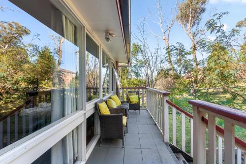 a balcony of a house with chairs and windows at 3-Bed Pet-Friendly Retreat Near Wentworth Falls in Wentworth Falls
