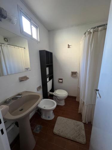 a bathroom with a sink and a toilet and a window at Rubí Department in Santa Rosa