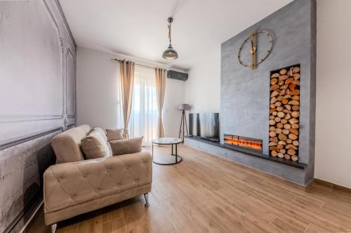 a living room with a couch and a fireplace at Impressive Premium Apartment in Nikšić