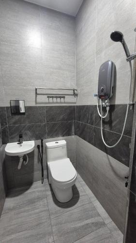 a bathroom with a toilet and a sink at Durrani's Homestay in Mersing