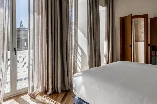 Letto o letti in una camera di Mercer Plaza Sevilla 5 GL