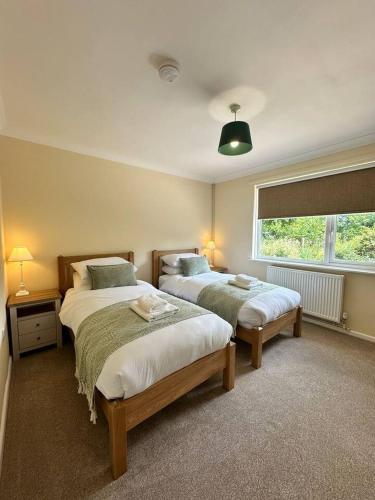a bedroom with two beds and a window at Pendene in Hinton