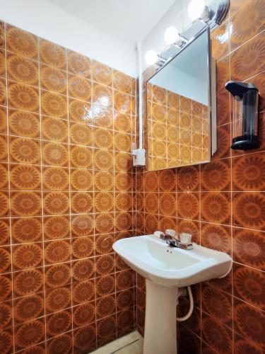 a bathroom with a sink and a mirror at Kokomo Hotel in Culebra