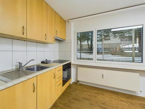 an empty kitchen with a sink and a window at Alpine Retreat 4 Person Apartment near Zermatt with parking! in Täsch