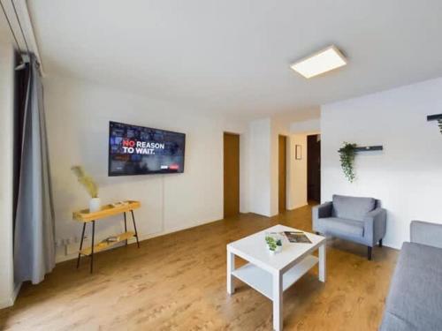 a living room with a couch and a table at Alpine Retreat 4 Person Apartment near Zermatt with parking! in Täsch