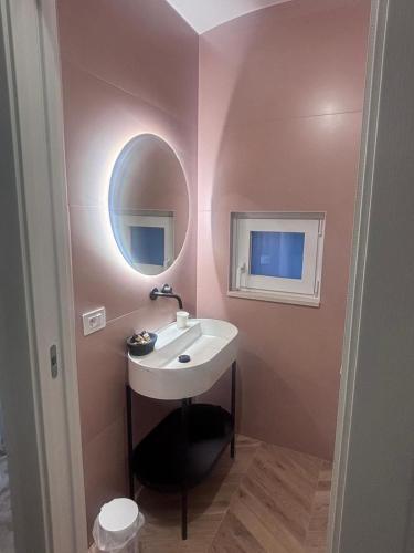 a bathroom with a sink and a mirror at DORO' suite & luxury rooms in Noci