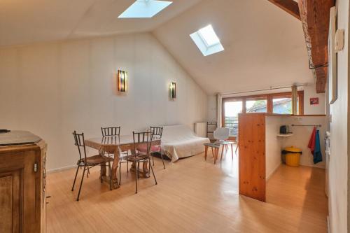 a room with a table and chairs and a bedroom at Maison Dans Ancienne Forge in Noyarey