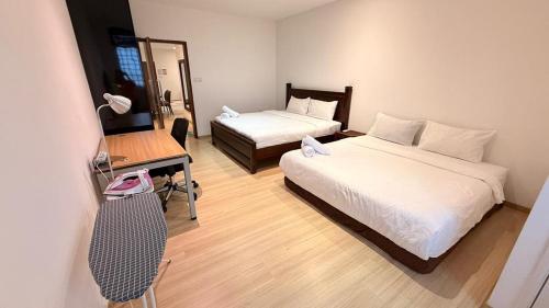 a hotel room with two beds and a desk and a chair at 118 Island Plaza Tg Tokong Gurney Straits Quay 1BR 1CP Wifi 4pax in George Town