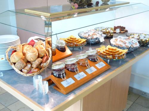 a display case with different types of bread and jams at AMBER ECONTEL in Munich
