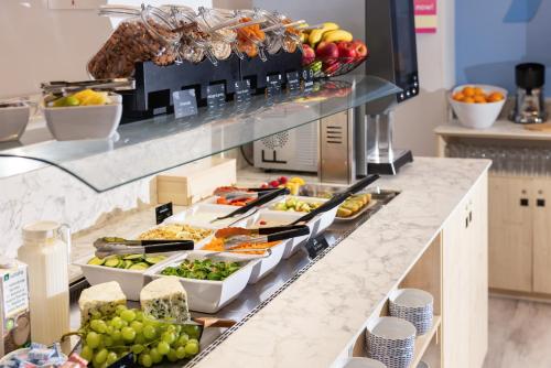 a buffet line with a variety of food on it at Hôtel Byakko Nice in Nice