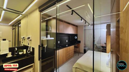 a bathroom with a glass shower and a sink at Flats no Nixxus Residence (Flats da Elena) in Porto De Galinhas