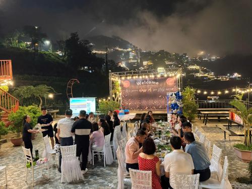 a crowd of people sitting around a table at a party at Happy Villa Tam Đảo in Tam Ðảo