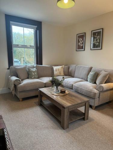 a living room with a couch and a coffee table at Waterditch Farmhouse in Winkton