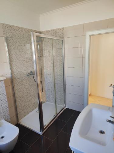 a bathroom with a shower and a toilet and a sink at Apartments Marija in Trogir