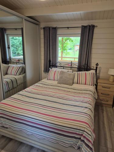 a large bed in a room with a window at Nellies Cottage B&B & Log Cabins in Kilcogy