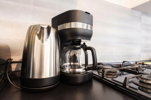 a coffee maker sitting on top of a stove at Appartement dans un charmant village avec parking in Sevremont