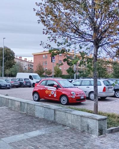 a red car parked in a parking lot at Casa Darla in Cesano Boscone