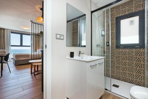 a bathroom with a sink and a mirror at Palm Suites in Estepona