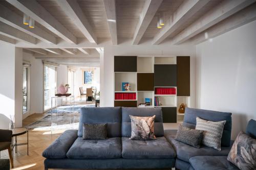 a living room with a large blue couch at Villa Sebino Relais in Tavernola Bergamasca