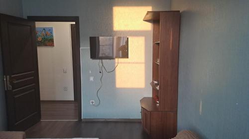 a living room with a tv on the wall at Xaldan hotel in Baku