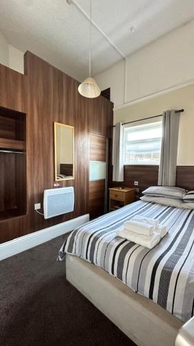 a bedroom with a bed and a television in it at Shanahans B&B with Sports Bar in Birmingham