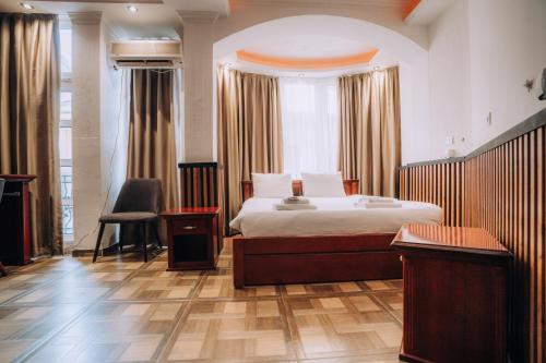 a bedroom with a bed and a large window at District&Villa De Lago in Ohrid