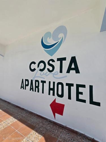 a sign for a port hotel on a wall at Costa Love Hotel Aeropuerto in Punta Cana