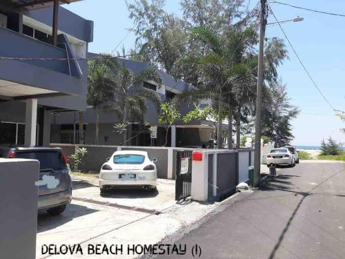 a parking lot with cars parked in front of a building at Delova Seaside in Kuala Terengganu
