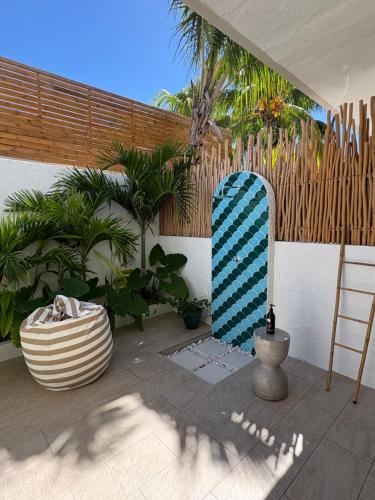 a blue and white surfboard sitting on a patio at Searenity Villas in Rivière Noire