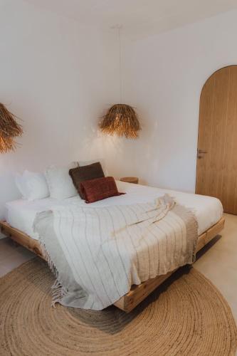 a bedroom with a large bed with a rug at Searenity Villas in Rivière Noire