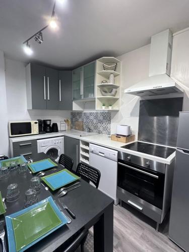 a kitchen with a table and a stove top oven at Le Cocon Familiale - Disneyland paris in Chessy
