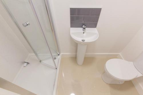 a white bathroom with a toilet and a sink at Radstock Road - Room 1 in Southampton