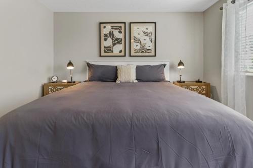 a large bed in a white bedroom with two lamps at Newly Remodeled Home Near Zion - Outdoor Grill in La Verkin