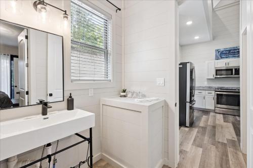 a white kitchen with a sink and a mirror at Smoky Shores Lakeview Cabin By Beyond Expectations in Sandy Ridge