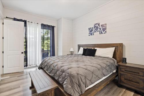 a bedroom with a large bed and a window at Smoky Shores Lakeview Cabin By Beyond Expectations in Sandy Ridge