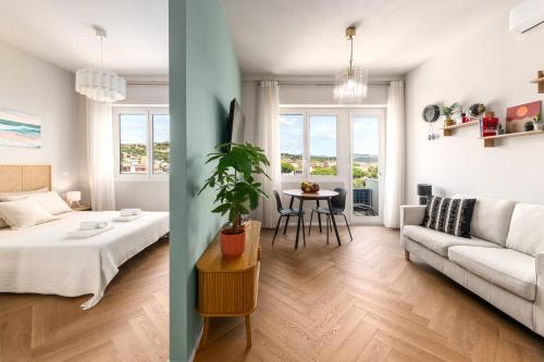 a living room with a couch and a table at Riviera Suite in Santa Marinella