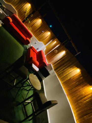 a kitchen counter with a wooden cutting board and lights at rooz Hotel apartments in Aqaba