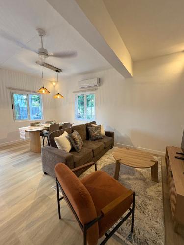a living room with a couch and a table at Searenity Villas in Rivière Noire