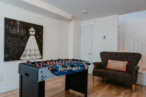 a room with a foosball table and a chair at St Johns Retreat Terrace 3 BR & 2 Baths in St. John's