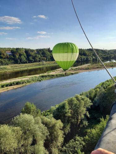 a hot air balloon flying over a river at ENTRE LOIRE ET CHER Chambres d'Hôtes in Tour-en-Sologne