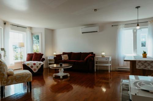 a living room with a couch and a table at St Johns Retreat Terrace 3 BR & 2 Baths in St. John's