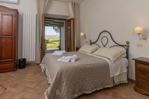 a bedroom with a bed with two towels on it at Agriturismo San Marcello in Castiglione dʼOrcia