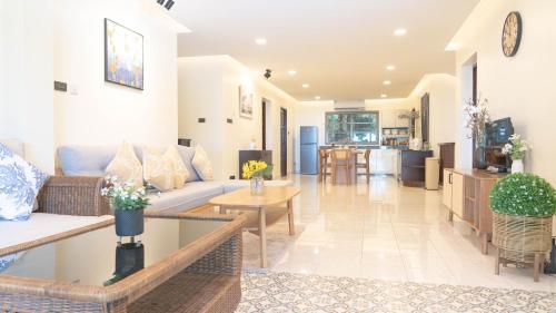 a living room with a couch and a table at Jaokhun Hilltop Patong, Phuket in Patong Beach